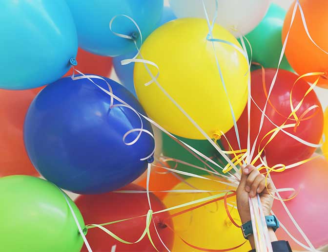 A bunch of balloons, inviting you to celebrate your birthday at CSM.