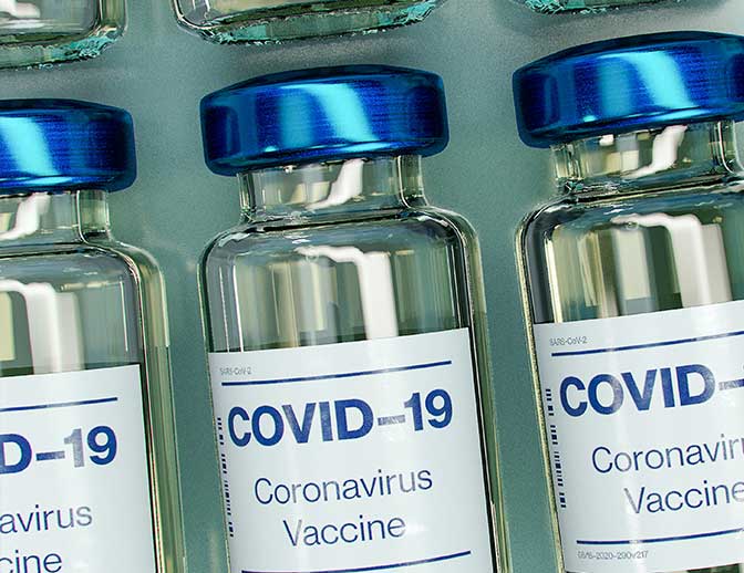 A line of Covid-19 vaccine bottles.