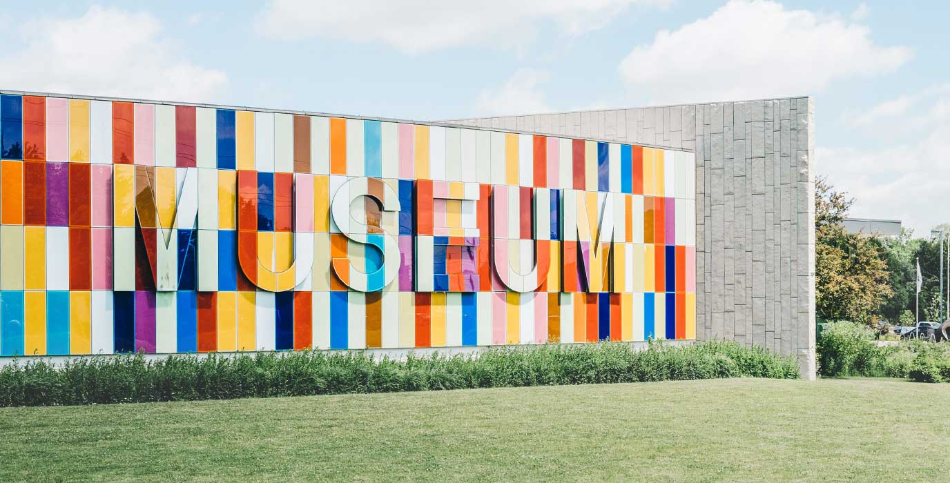 Frontside of the CSM museum, with grass and blue sky surrounding it.