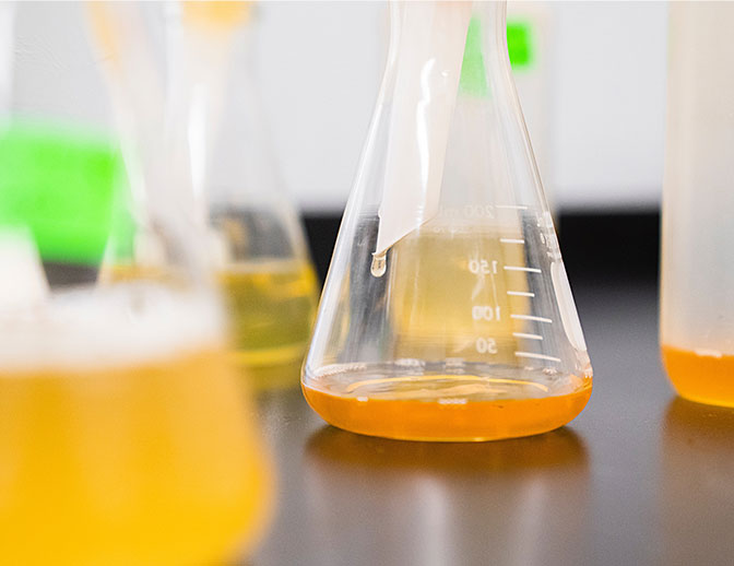 Testing glass with chemicals inside, on a table.